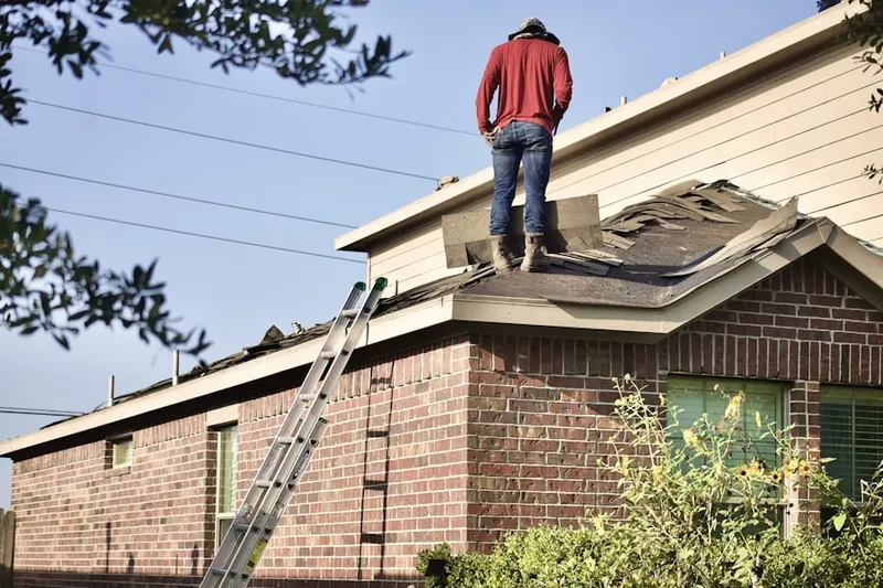 Professional roofer working on a residential roof in Florissant
